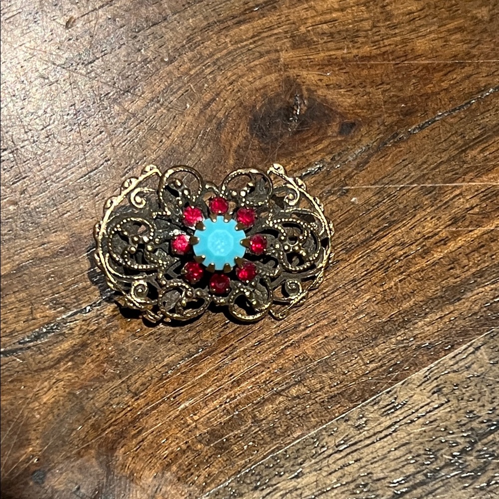 Vintage antiqued silver-tone filigree brooch blue cabochon stone red rhinestones